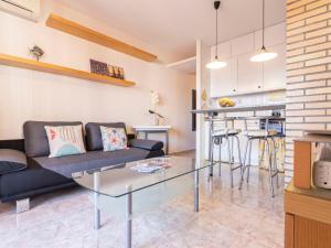 a living room with a couch and a glass table at Apartment Torrepuerto by Interhome in Torredembarra