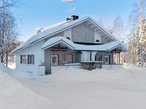 a house covered in snow in the snow at Holiday Home Hallantytär b3 paritalo by Interhome in Hyrynsalmi