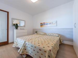 a bedroom with a bed and a dresser at Apartment Reus Mediterraneo by Interhome in Vilafortuny