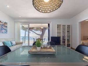 a living room with a glass table and a couch at Apartment Reus Mediterraneo by Interhome in Vilafortuny