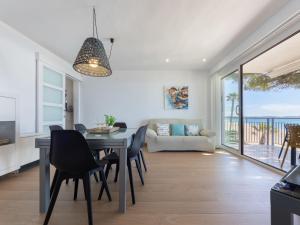 a dining room and living room with a table and chairs at Apartment Reus Mediterraneo by Interhome in Vilafortuny