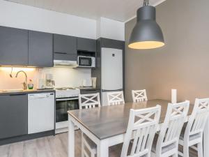 a kitchen with a table and chairs in a room at Holiday Home Skivillas paljakka 1- - 3 bedroom by Interhome in Kotila