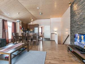 a living room with a table and a dining room at Holiday Home Hallan karhu c- paritalo by Interhome in Hyrynsalmi