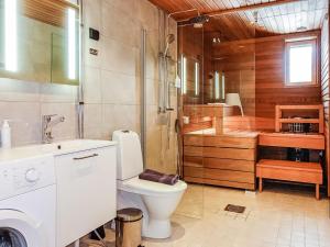 a bathroom with a toilet and a shower and a sink at Holiday Home Levin kunkku b5 by Interhome in Levi