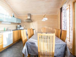a kitchen and dining room with a table and chairs at Holiday Home Rinteenkotka cottage by Interhome in Hyrynsalmi