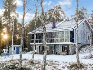 a house in the snow with trees at Holiday Home Äkäsjärven lomamökit 2 by Interhome in Muonio