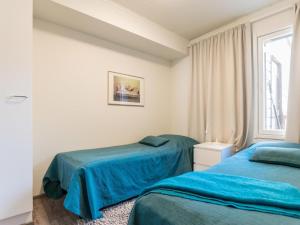 En eller flere senge i et værelse på Holiday Home Skivillas 61 ukkohalla - b8 by Interhome