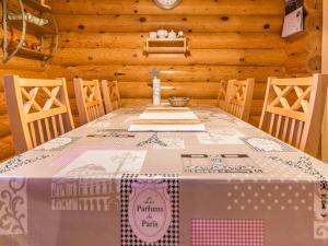 a table in a cabin with a table cloth on it at Holiday Home Kultapaljakka 4 by Interhome in Kotila