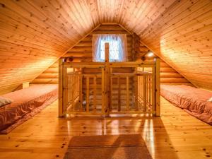 a room in a log cabin with two beds at Holiday Home Metsätähti by Interhome in Kotila +6 photos