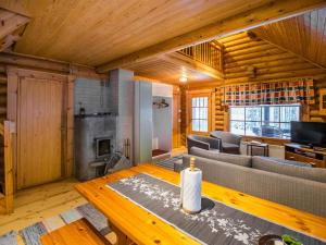 a living room with a couch and a table at Holiday Home Metsätähti by Interhome in Kotila