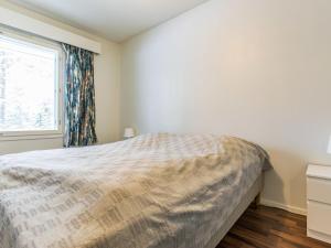 a bedroom with a bed and a window at Holiday Home Kotipaljakka a1 by Interhome in Kotila +5 photos