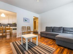 a living room with a couch and a table at Holiday Home Kotipaljakka a1 by Interhome in Kotila