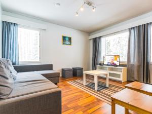 a living room with a couch and a tv at Holiday Home Kotipaljakka a1 by Interhome in Kotila
