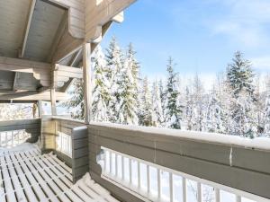 a balcony with a view of snow covered trees at Holiday Home Ukkoloma b paritalo by Interhome in Hyrynsalmi