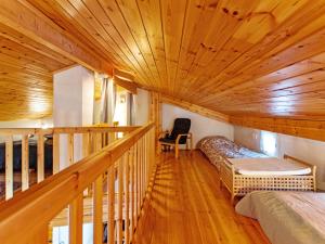 a room with two beds and a staircase in a cabin at Holiday Home Lomarivi c4 by Interhome in Kotila +10 photos