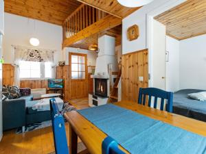 a room with two beds and a couch and a fireplace at Holiday Home Lomarivi c4 by Interhome in Kotila