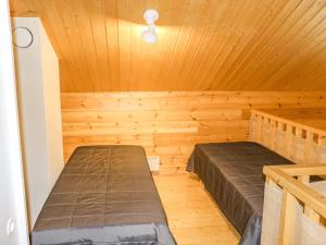 a room with two beds in a sauna at Holiday Home Miilumaja a2 by Interhome in Kotila