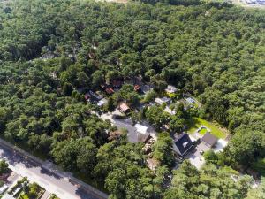 an overhead view of a house in the middle of a forest at Holiday Home De Brenkberg in Schinveld