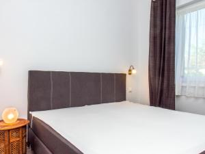 a bedroom with a large bed and a window at Holiday Home Francois by Interhome in Balatonberény