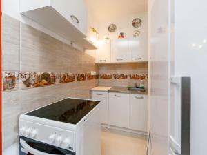 a kitchen with white cabinets and a stove at Apartment Tilia 3 by Interhome in Balatonberény +23 photos