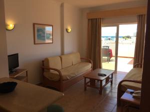 a living room with a couch and a tv at Prestige for Home - Apt Alagoa Praia Altura in Altura