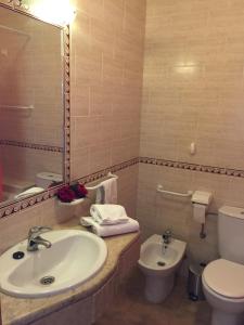 a bathroom with a sink and a toilet and a mirror at Prestige for Home - Apt Alagoa Praia Altura in Altura