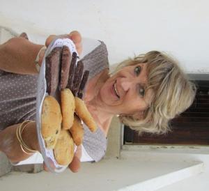 eine Frau mit einem Behälter aus Hot Dogs und Donuts in der Unterkunft The Artist's House Overlooking the Bay of Haifa in Haifa