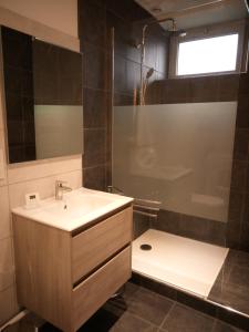 a bathroom with a sink and a shower and a tub at Gite de charme Les Buissonnets in Plesder