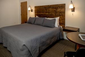 a bedroom with a large bed and a table at Eagle Cap Chalets in Joseph