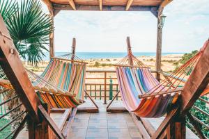 two hammocks on a porch overlooking the beach at Victory Apartments & Hotel (Block C) in Samothraki