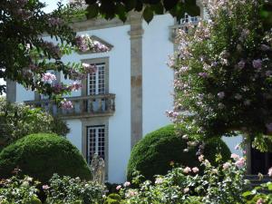a white house with trees in front of it at Douro - A Casinha da Ana in Vila Real