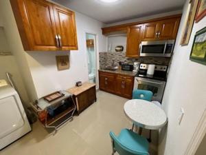 a small kitchen with a table and a stove at Rim Canal Cottage 'Yellow House' with Canal Views & Boat Dock cottage in Okeechobee