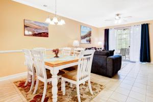a dining room and living room with a table and chairs at Green Arbor in North Myrtle Beach