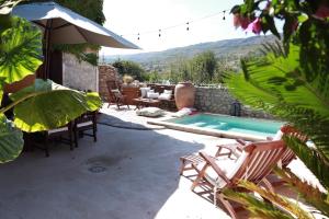 a patio with chairs and a swimming pool at Ca la Pasita 26 in Beniali