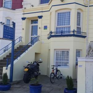 a motorcycle parked in front of a building at St Albans Guest House, Dover in Dover