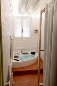 a white bath tub in a room with a window at La Perla del Doge con Wellness & Spa uso esclusivo - La Perla Apartments in Venice