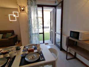 a living room with a table and a couch at BETULLA BIANCA in Bardolino