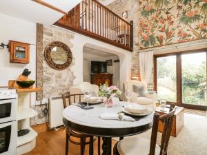 a kitchen and dining room with a table and chairs at The Granary in Edington