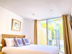 a bedroom with a bed and a large window at Amber Lodge Hickstead-B in Burgess Hill