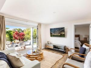 a living room with a couch and a table at Blue View Gerringong in Gerringong