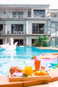 a swimming pool with a buffet of food in a resort at CHA AM MY HOUSE Resort in Cha Am