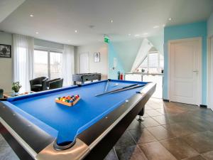 a pool table in a living room with at Lush holiday home on the edge of the Hautes Fagnes in Waimes