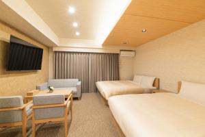 Postel nebo postele na pokoji v ubytování HOTEL WA HAKATA