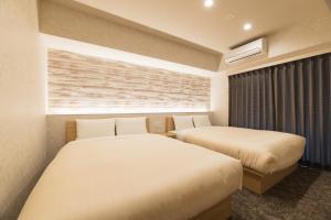 Postel nebo postele na pokoji v ubytování HOTEL WA HAKATA