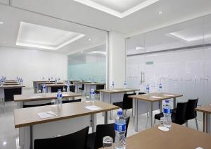 a classroom with tables and chairs with water bottles on them at Amaris Hotel Juanda in Jakarta