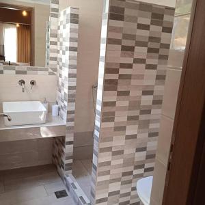 a bathroom with a sink and a toilet and a mirror at To limanaki in Finikounta +40 photos