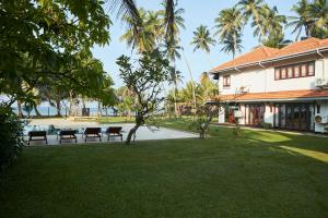 a yard with benches in front of a building at The Beach Villas by Ceylon Bungalows in Wadduwa