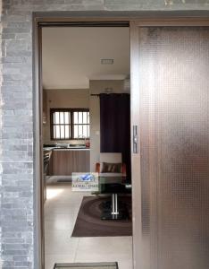 a view of a kitchen through a door into a room at bedroomed fully furnished apartment Near East Park Mall in Kabulonga