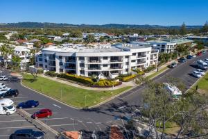 an aerial view of a large building in a parking lot at Bay Royal Apartments in Byron Bay