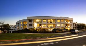 a car parked in front of a building on a street at Bay Royal Apartments in Byron Bay +158 photos